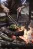 Cook food over an open flame