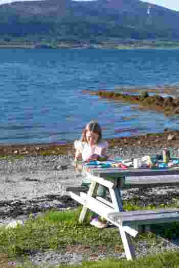 Kid painting by the sea